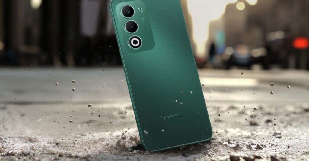 Green Color OPPO mobile is on the road Oppo A5 5G in Aurora Green shown on outdoor surface for lifestyle context