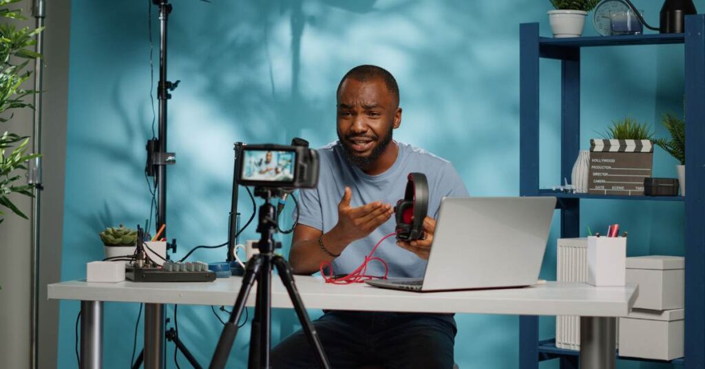Close up smartphone filming influencer sitting down on bench and smiling and interacting with fans