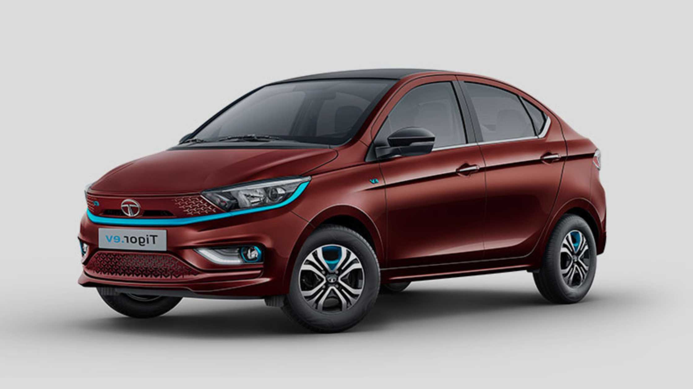 Front view of Tata Tigor EV electric sedan in white color with modern LED headlamps, displayed on Tata Motors official site electric cars under 15 lakhs