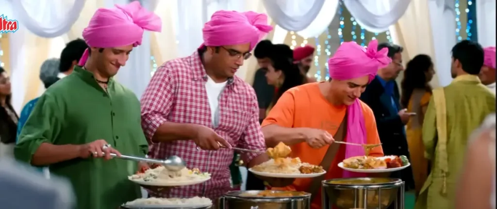 3 idiots Rancho, Raju, and Farahn they were in marriage and taking food from buffer and they were wear pink turbon