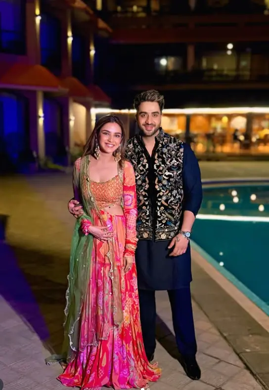 Aly Goni with Jasmin Bhasin posing together in traditional outfits near a poolside